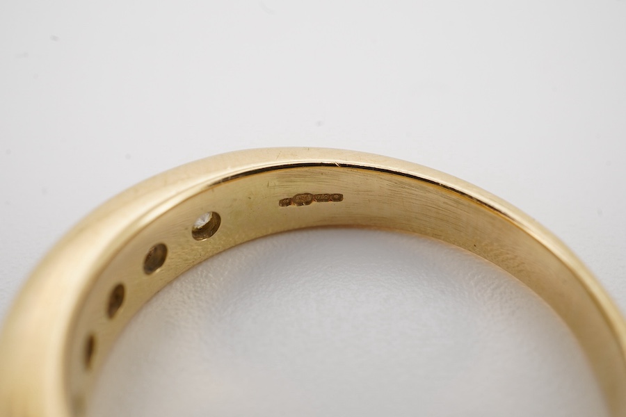 A modern 18ct gold and ten stone channel set diamond half hoop ring, size Q, gross weight 5.8 grams. Condition - fair to good